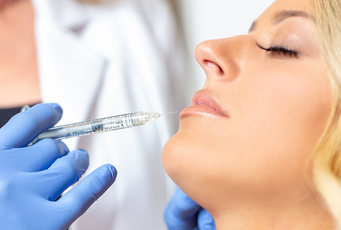 Client getting lip filler injection