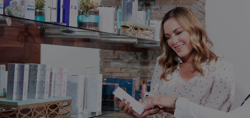 Woman looking at ingredients in skincare product