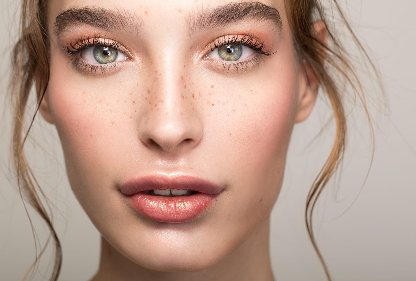 Close up of pretty woman with green eyes and freckles