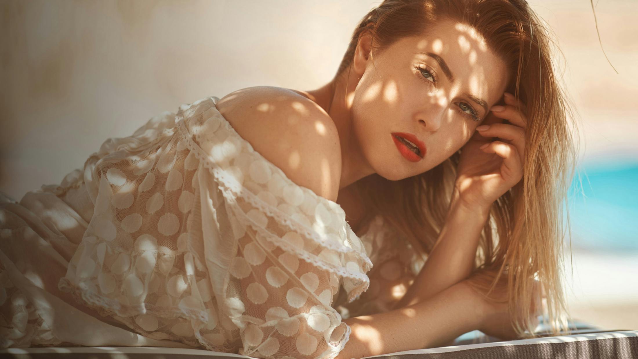 naked woman laying down with her arms and legs covering her body