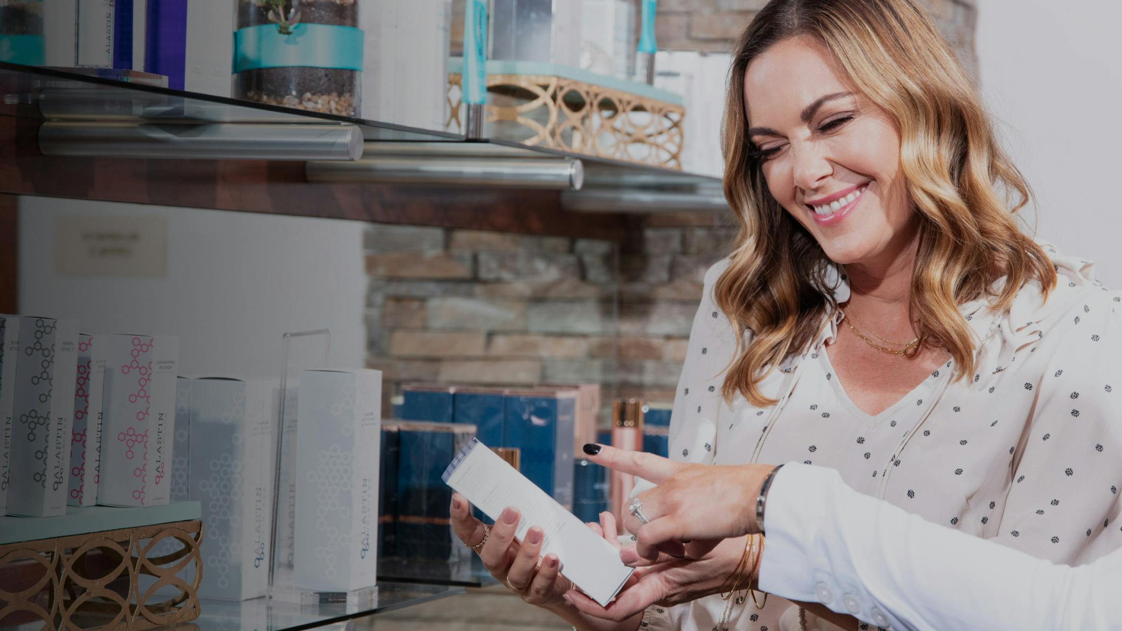 woman looking at a skincare product