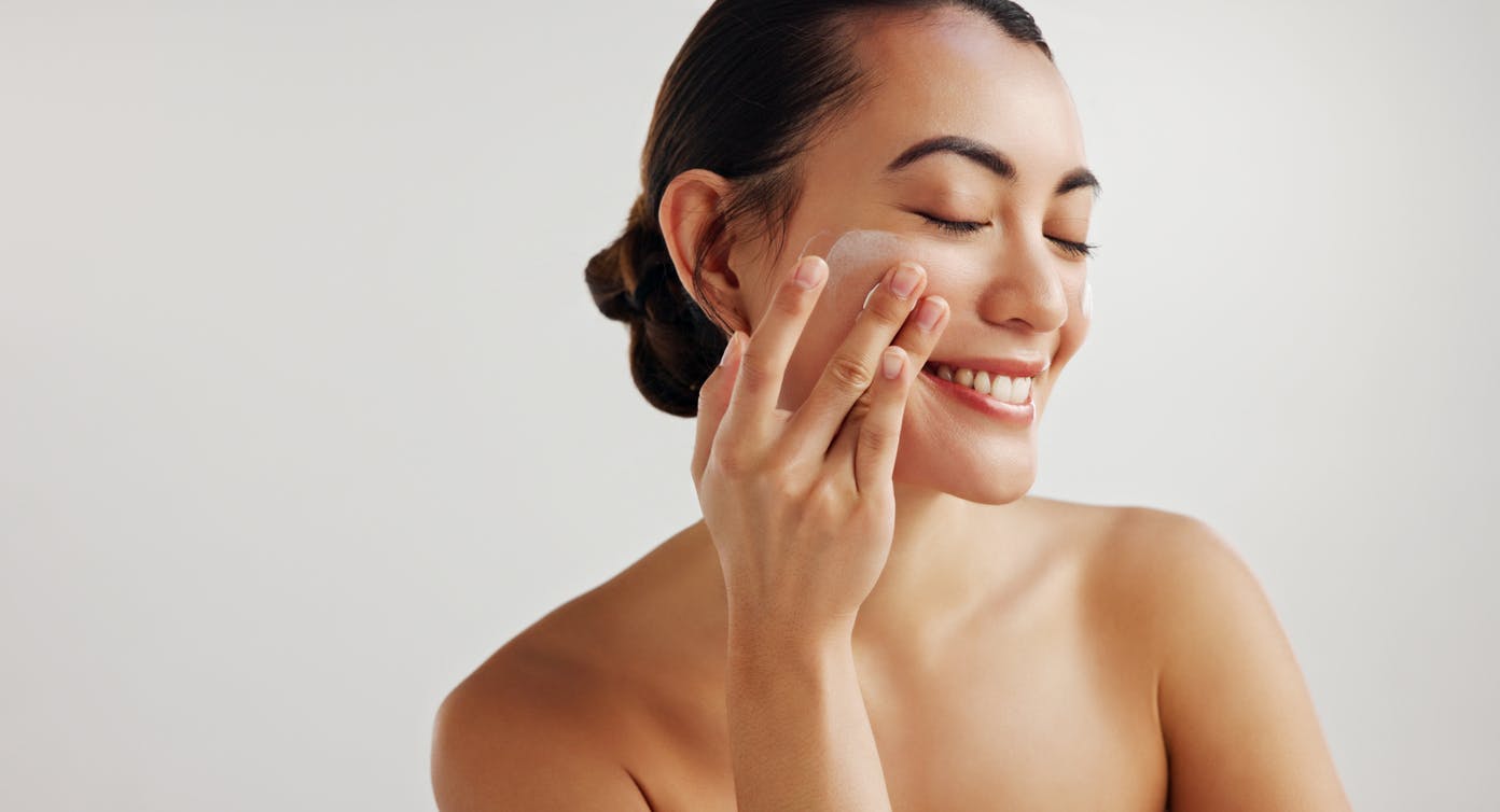 Woman putting on sunscreen
