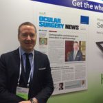 Dr. Waring standing in front of Ocular Surgery News display
