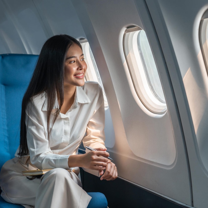 Woman looking out an airplane window