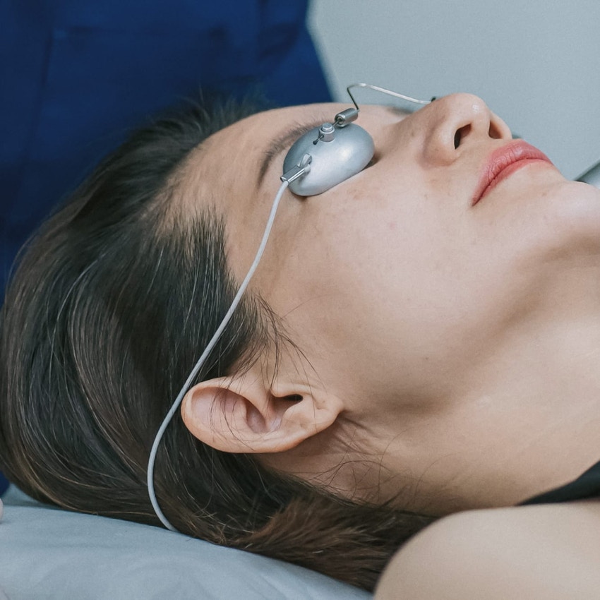 Woman with eye covers lying down