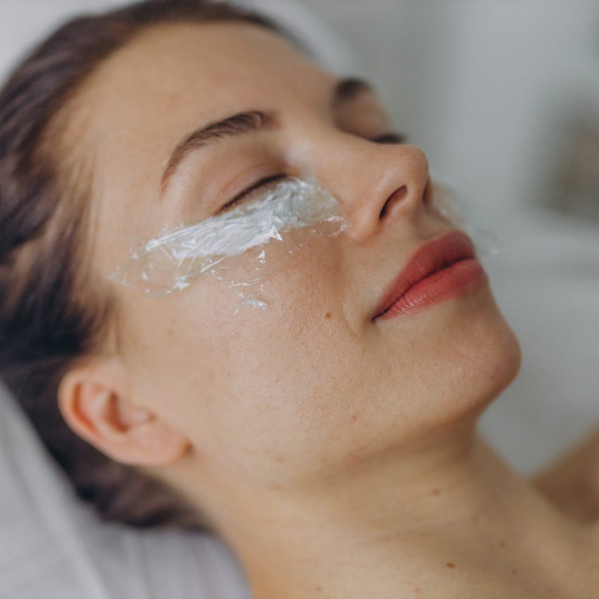 Woman during facial peel treatment