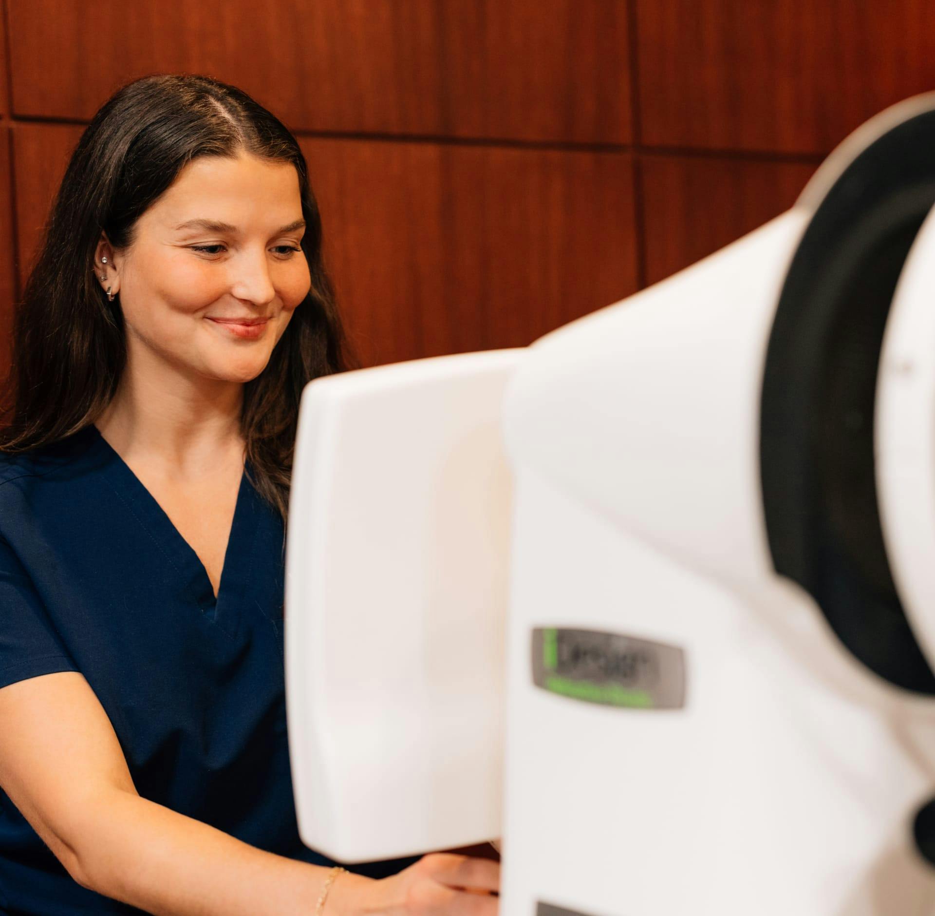 Doctor operating eye exam machine