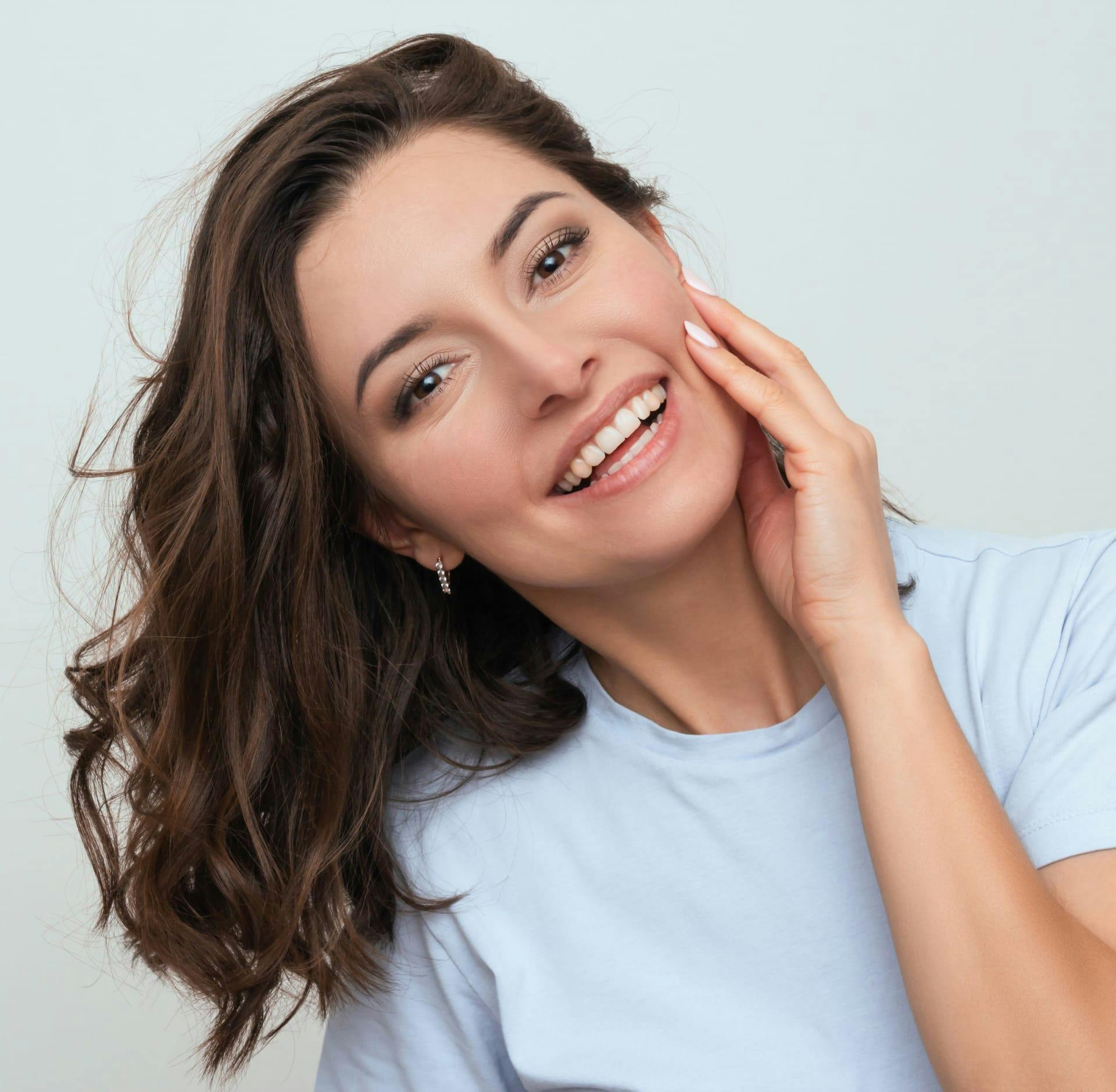 Woman smiling touching face