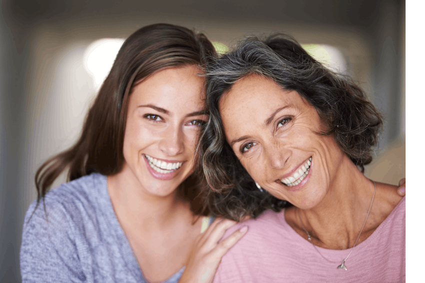 one young woman and one older woman smiling together