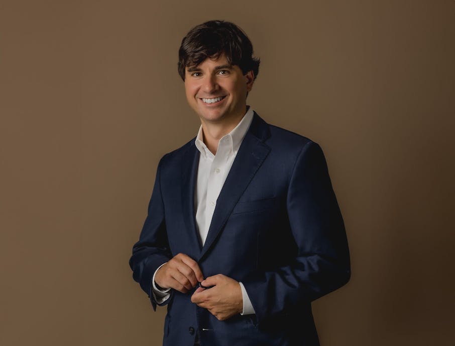 Will Lattimore in navy blue suit