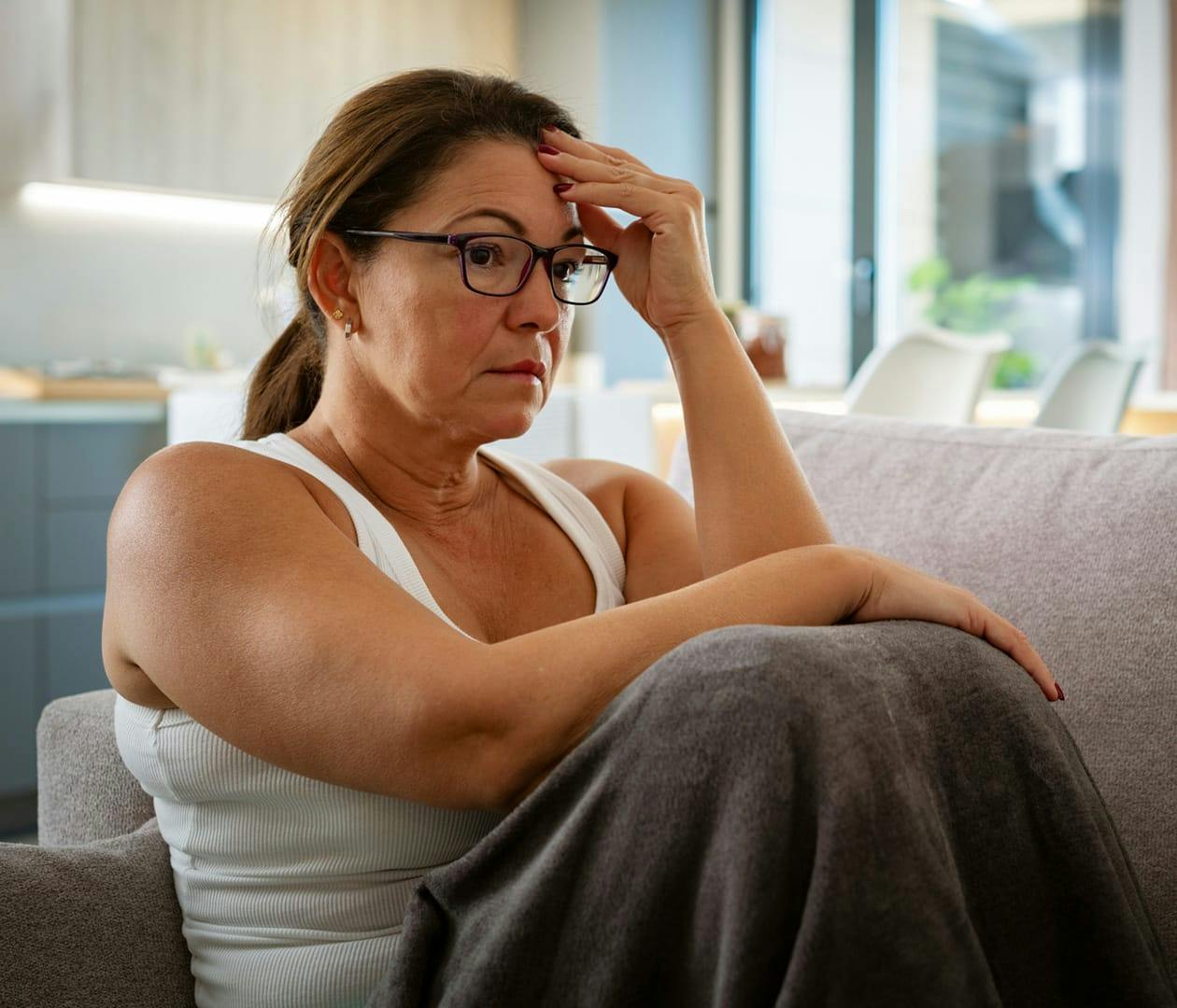 woman stressed out sitting on the couch