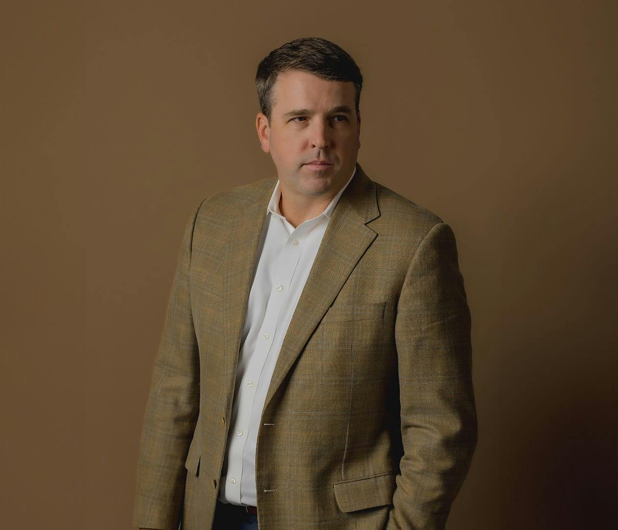 Brett Hollett in brown suit