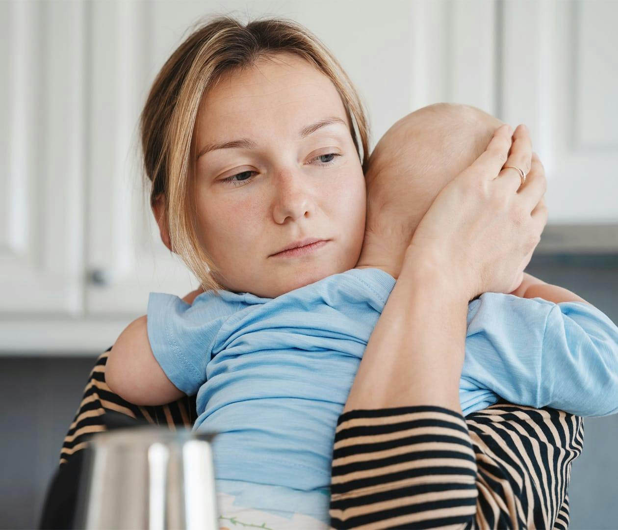 woman holding her newborn
