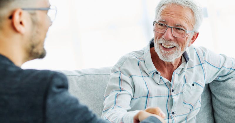 Men talking on a couch