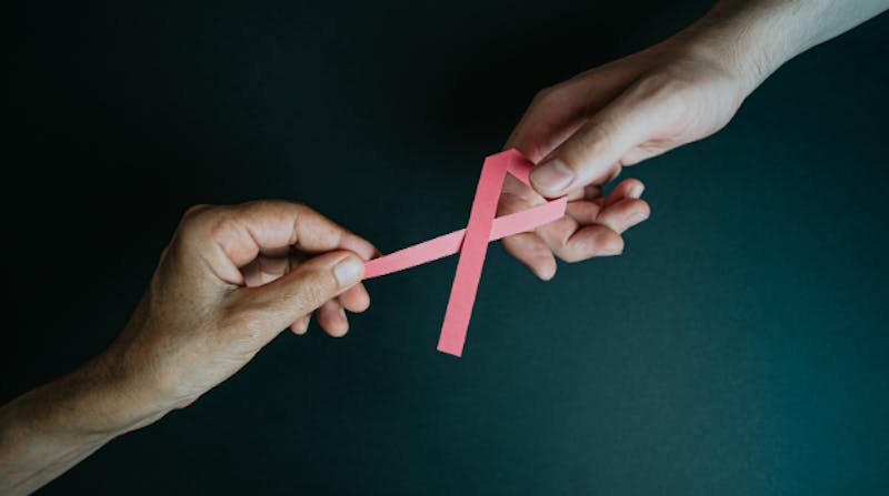 Hands holding a breast cancer ribbon