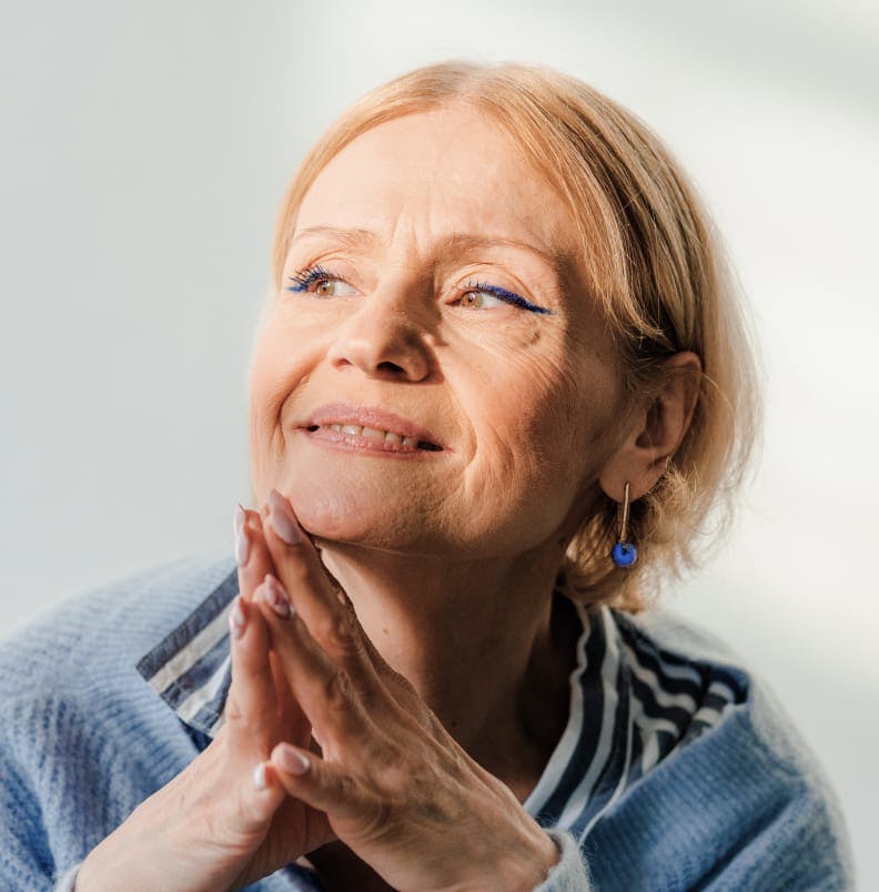 Woman with her fingers to her chin