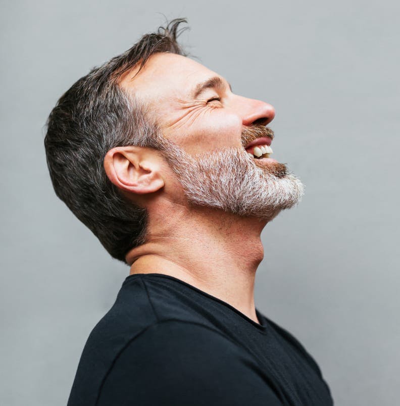 Profile of a smiling man with his eyes closed