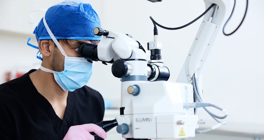 Doctor looking into equipment