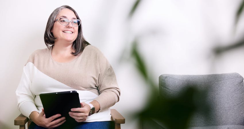 Woman smiling holding clipboard