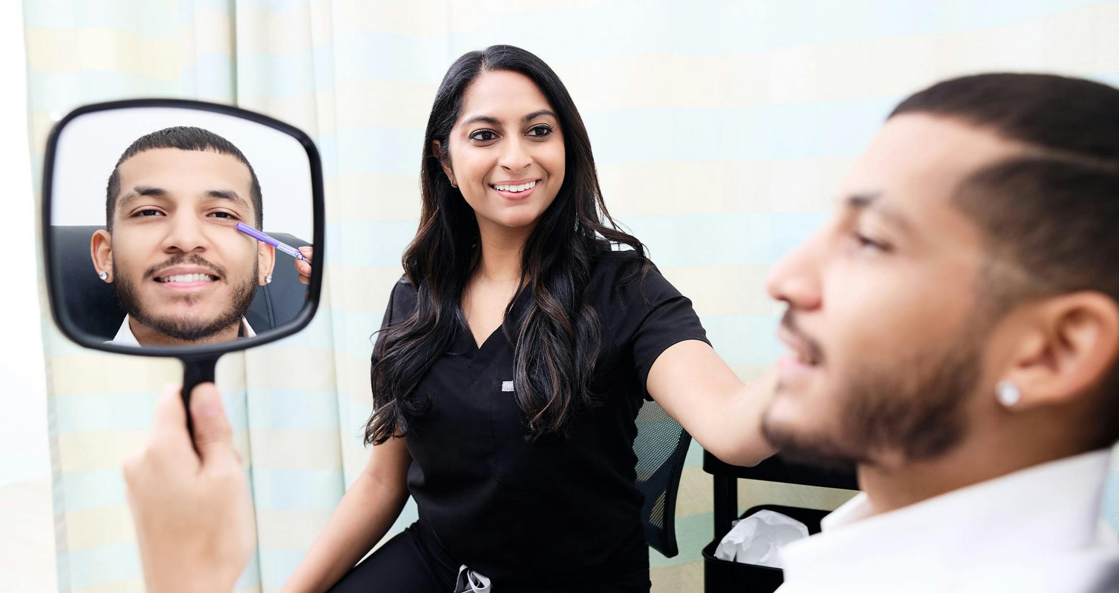 Man looking into mirror smiling