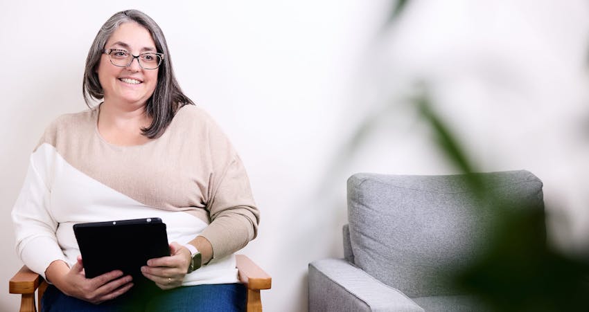 Woman smiling holding clipboard