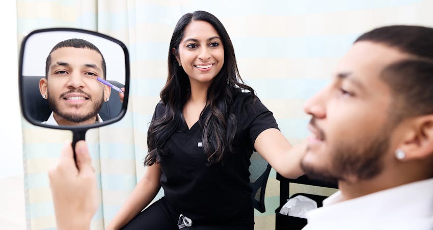 Man smiling while looking into mirror
