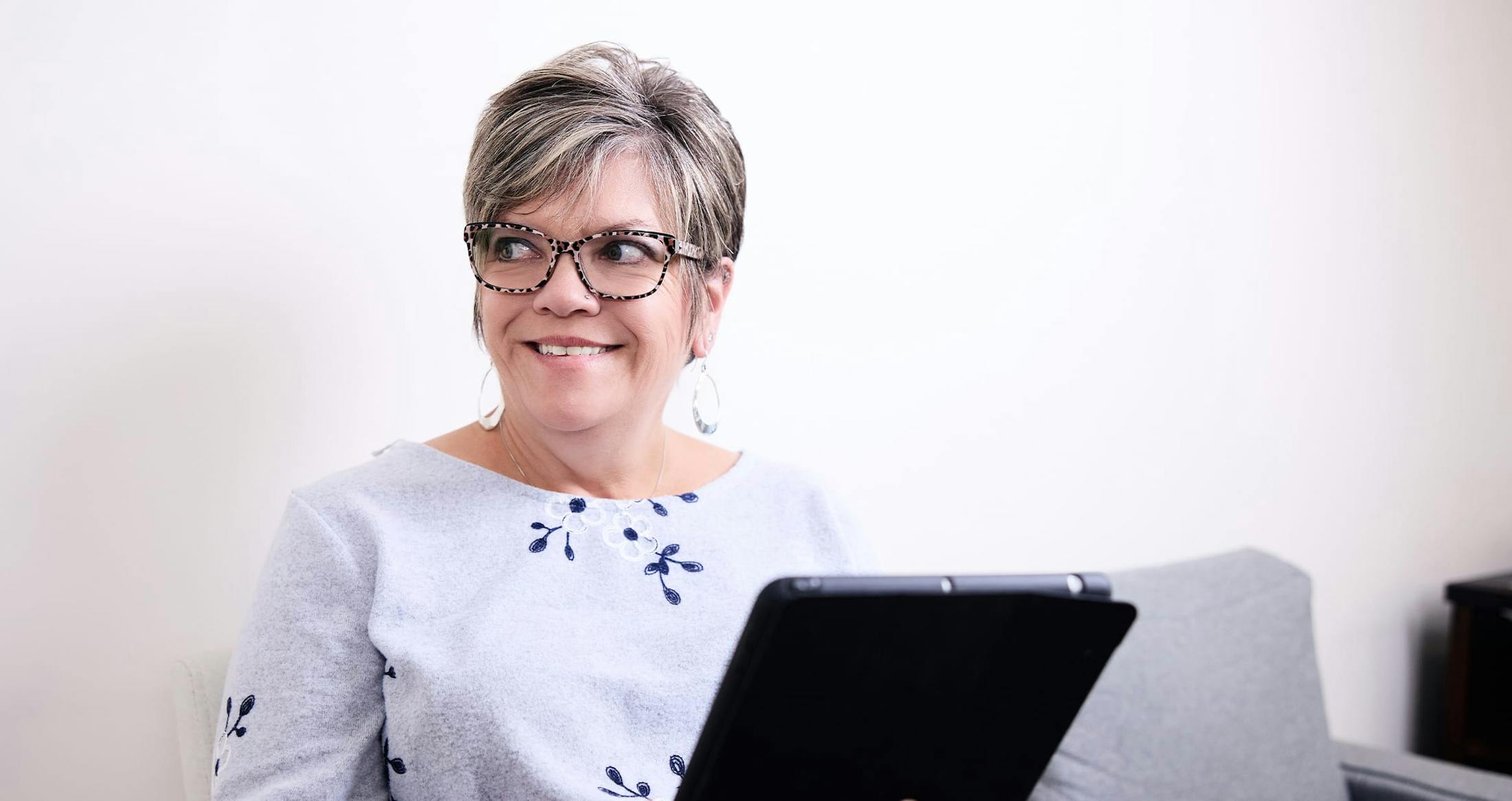 Woman smiling holding clipboard
