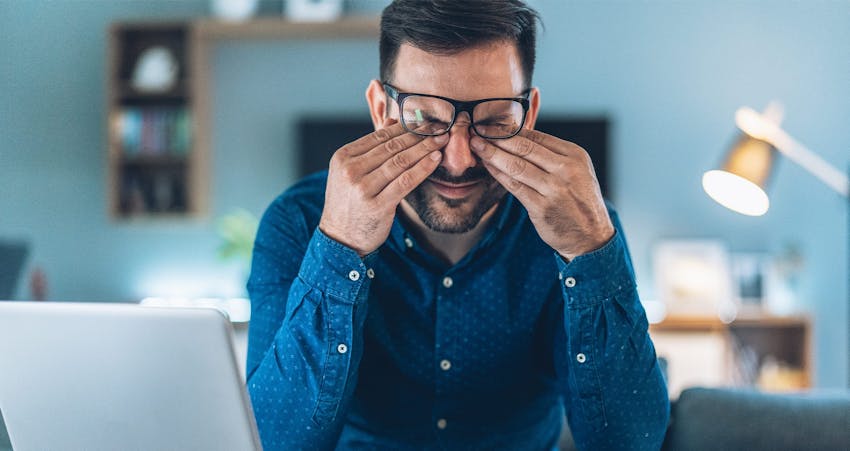 Man rubbing eyes