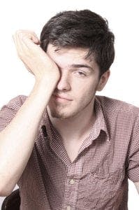 man rubbing his eye
