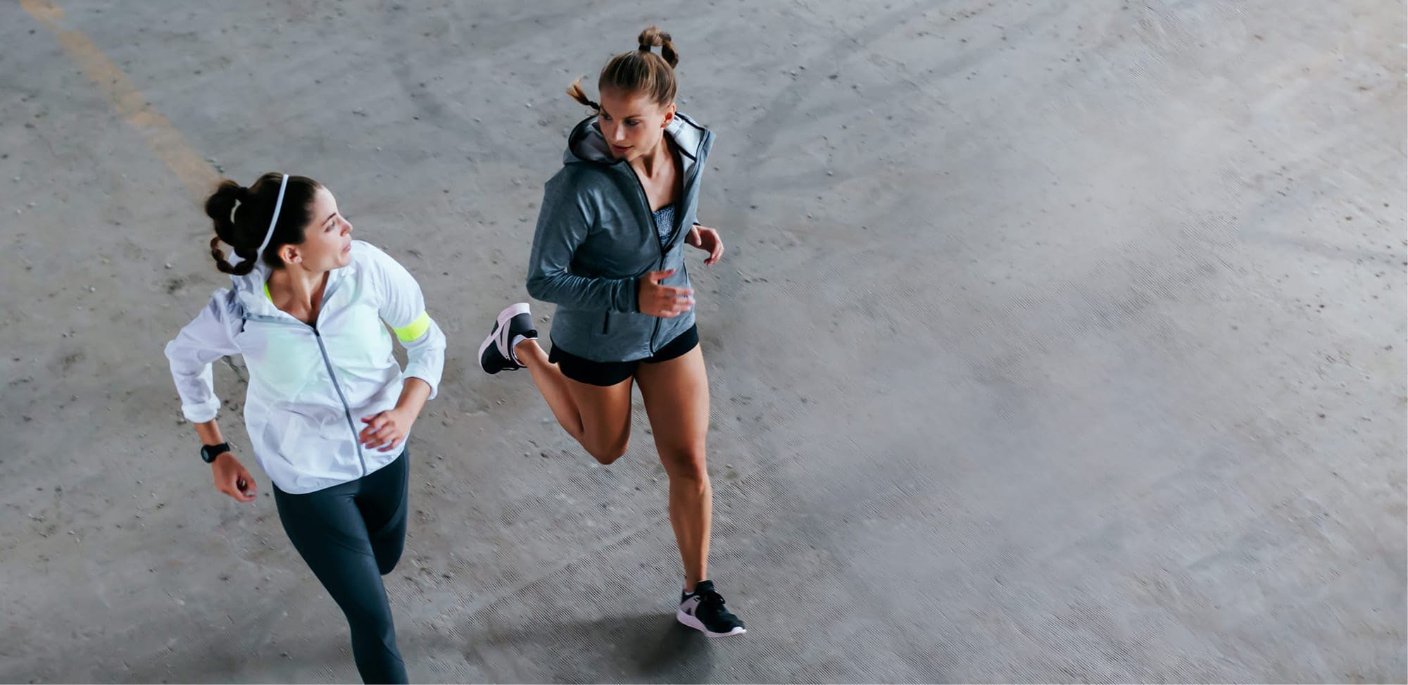 Two women outside running