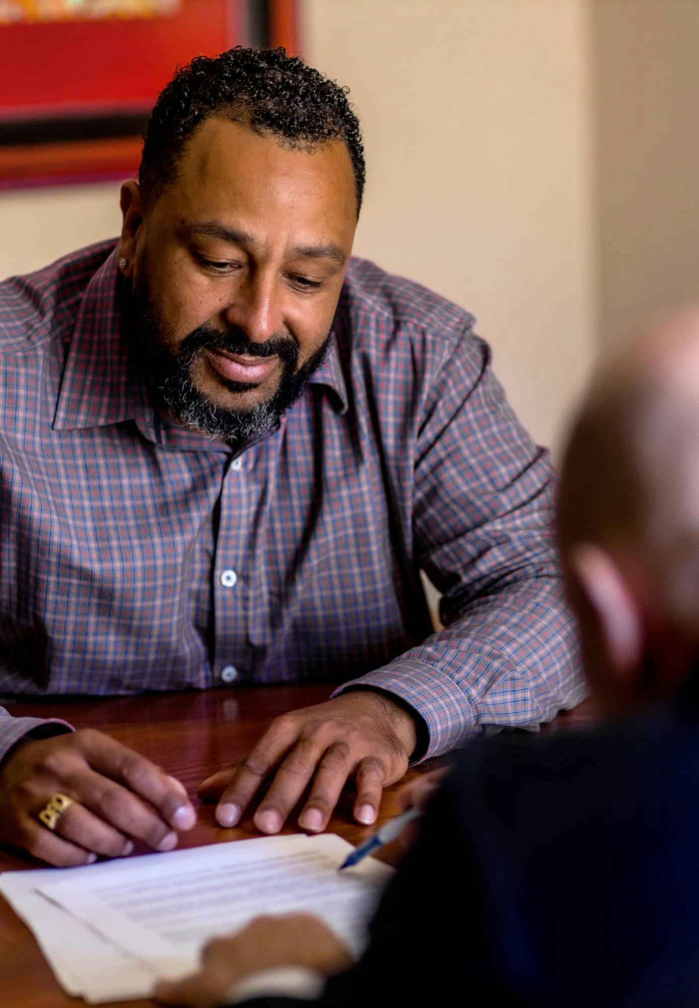 Christopher vader helping a male client.