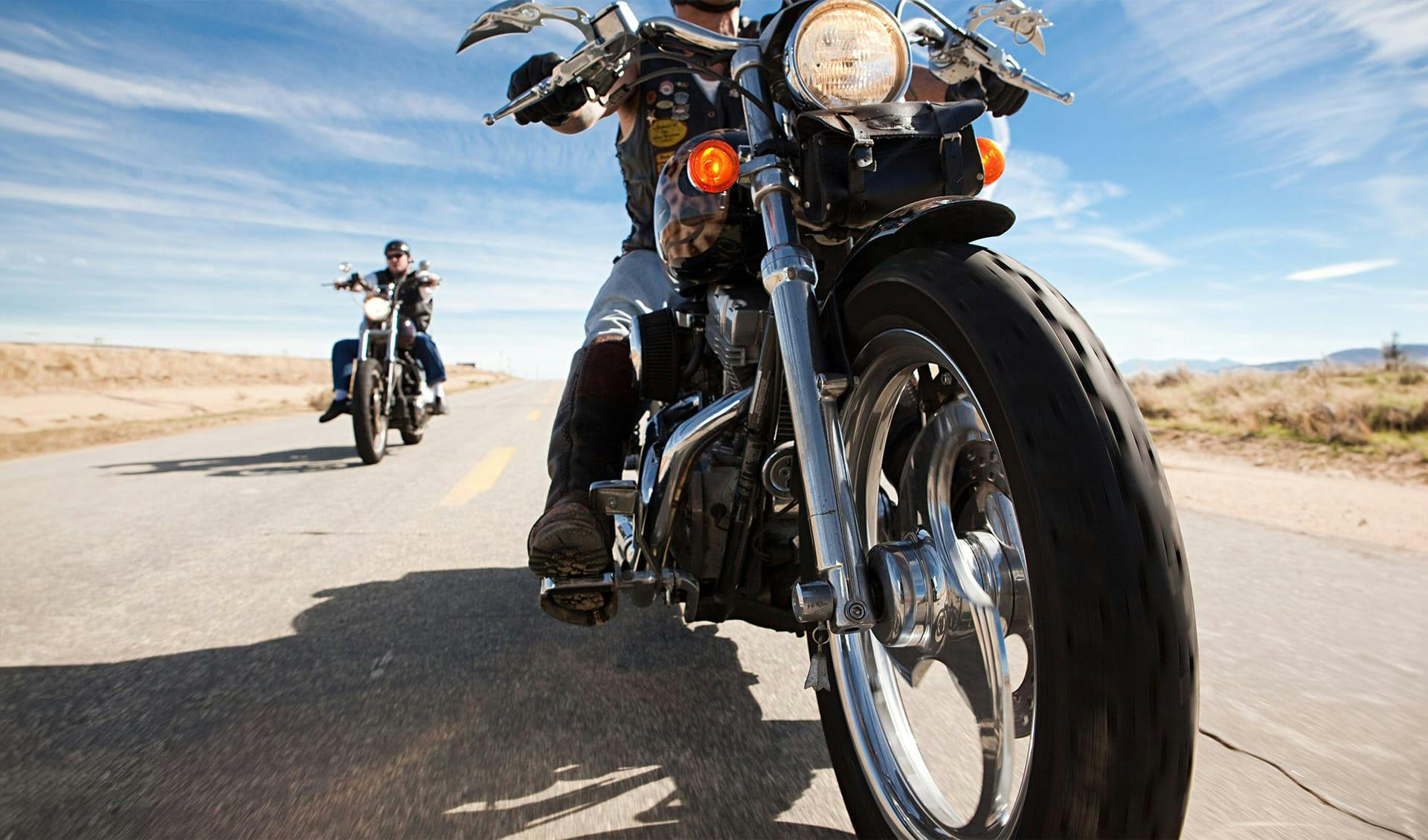 Two motorcycles driving down the highway