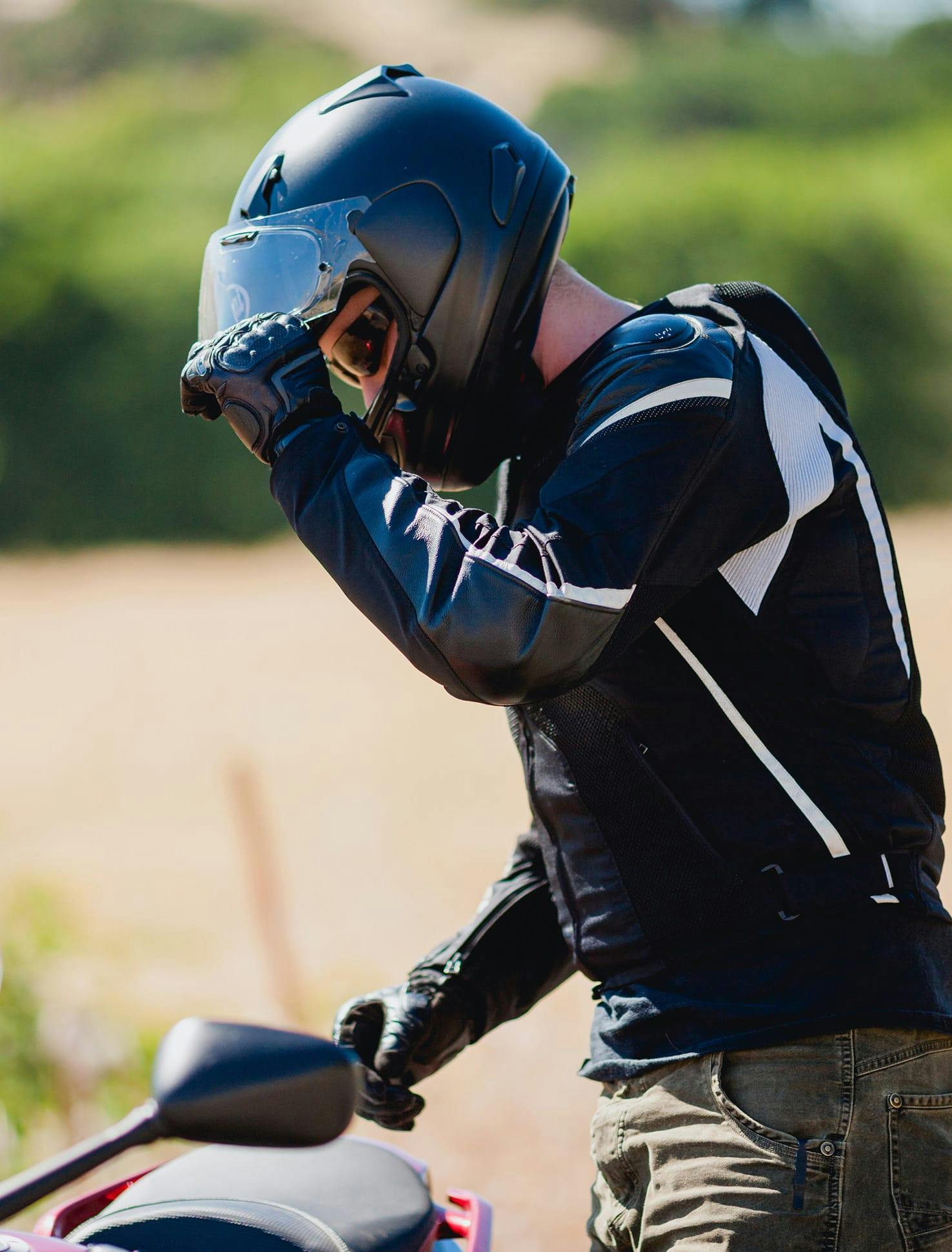 Man pulling helmet visor down