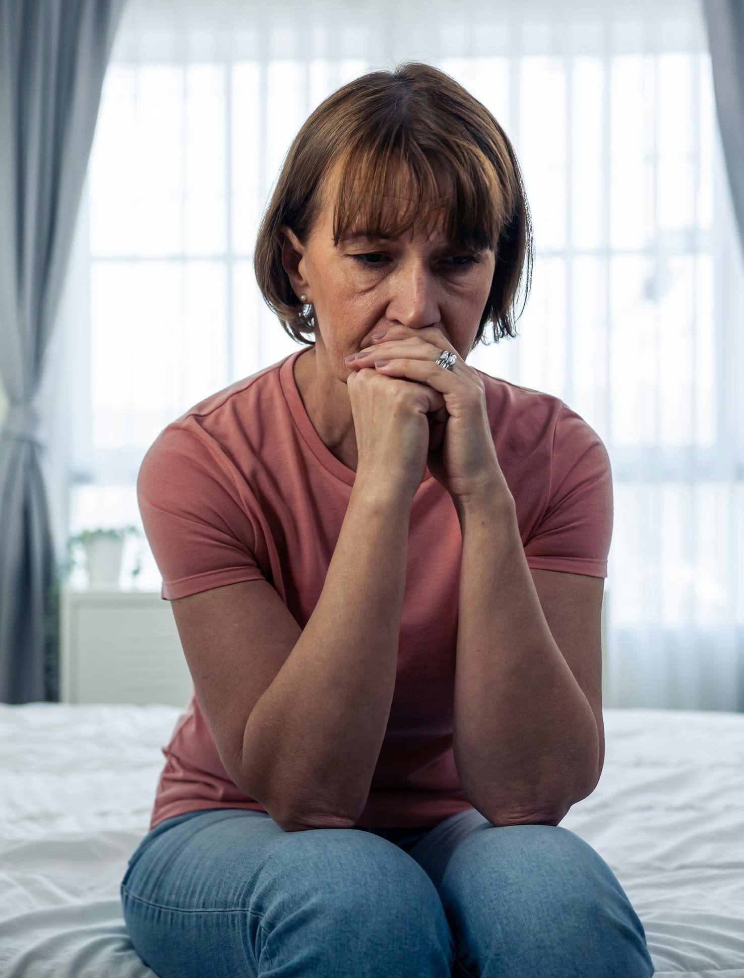 Woman with hands at mouth