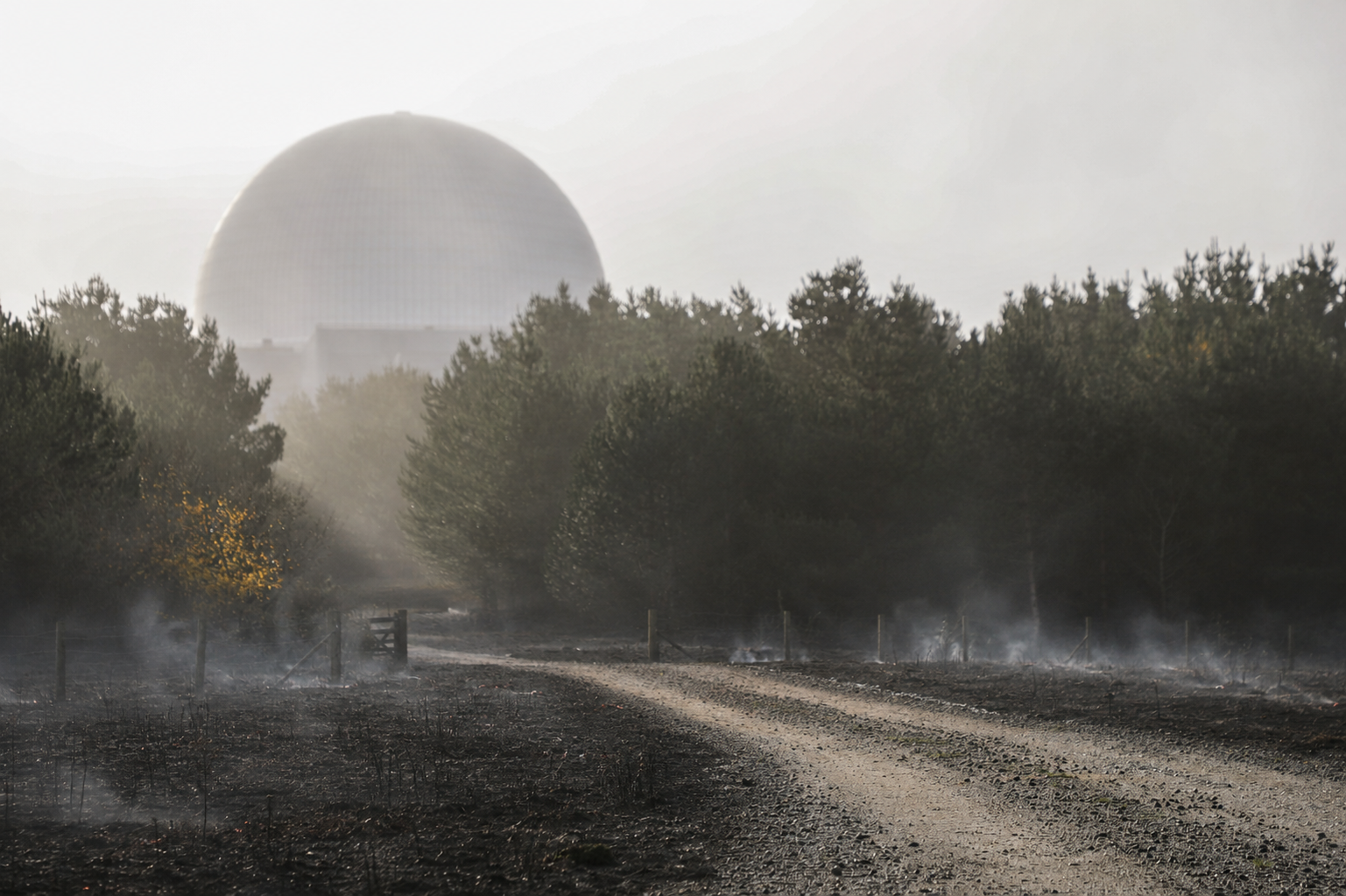 Sizewell C with ground smouldering outside (composite image)