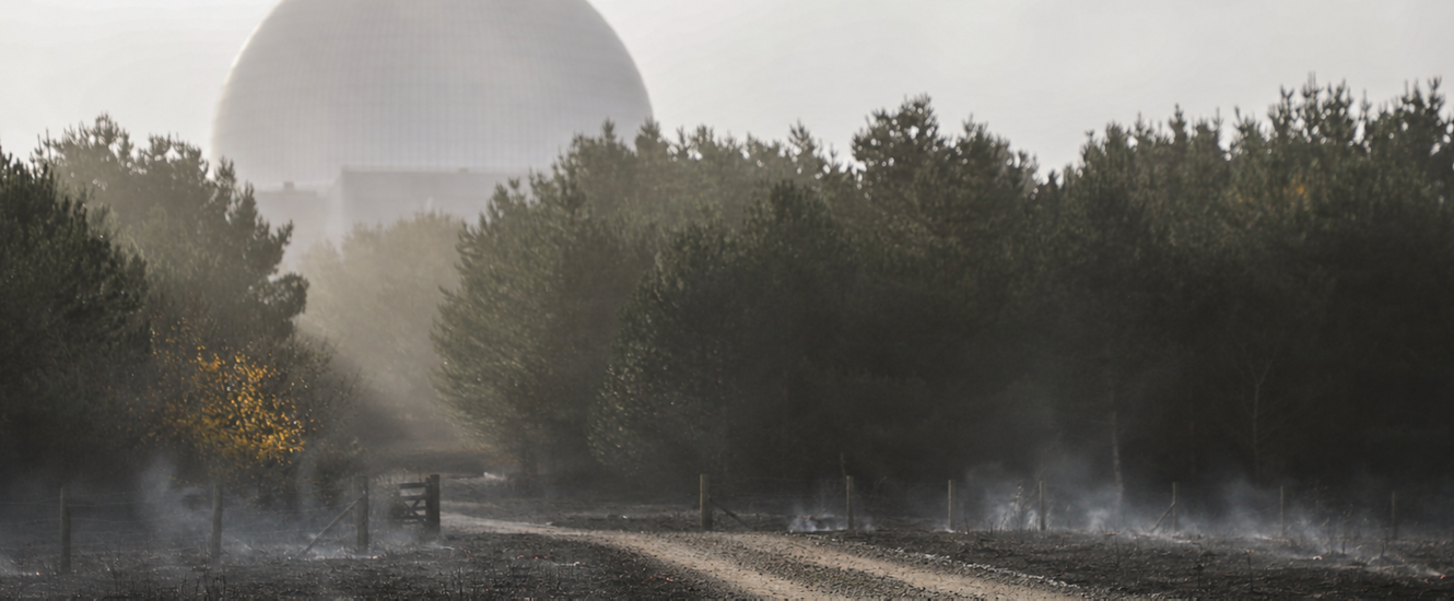 Sizewell C with ground smouldering outside (composite image)