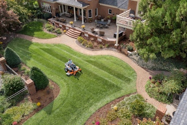Homeowners mowing lawn using STIHL zero turn mower