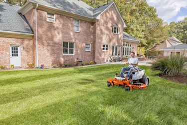 Man using STIHL zero turn mower in backyard