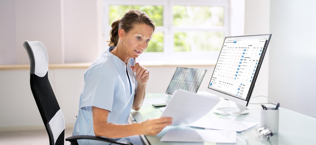 A manager for education in the care sector is looking at a spreadsheet