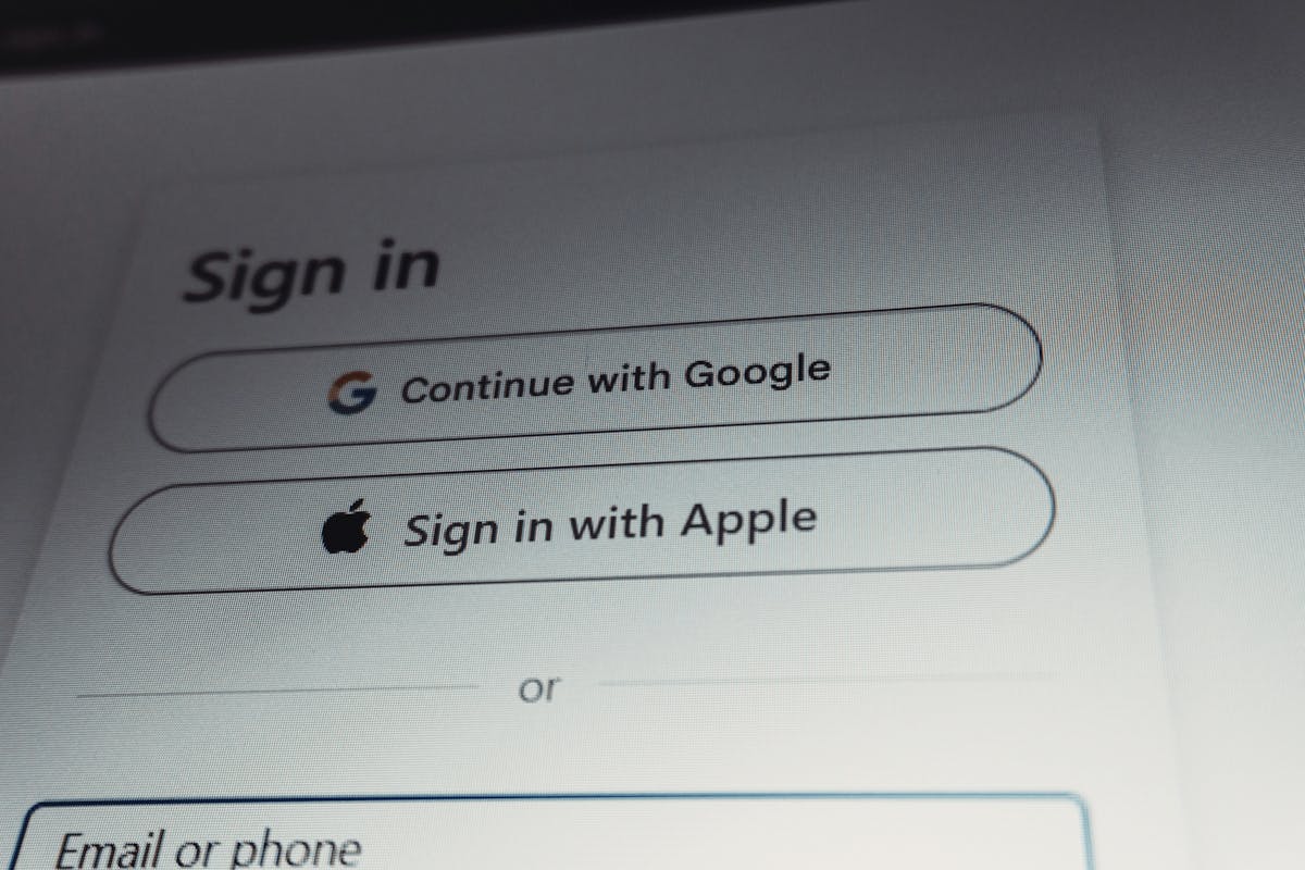 Sign-in screen showing options to continue with Google, sign in with Apple, or use email or phone