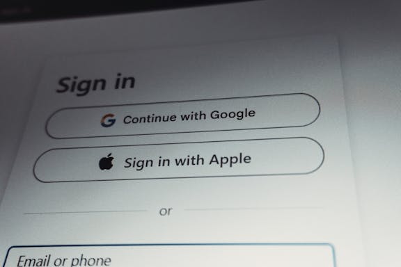 Sign-in form with social login options Sign-in screen showing options to continue with Google, sign in with Apple, or use email or phone
