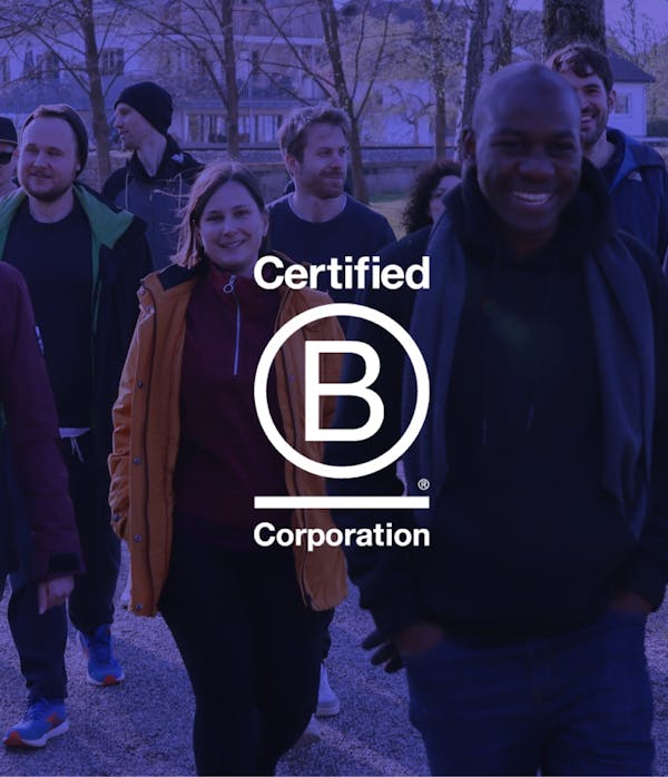 Peerigon certified as B Corporation Peerigon team with B Corp certification logo, group of people outdoors in park setting