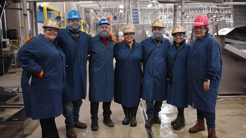 people in PPE in a manufacturing facility