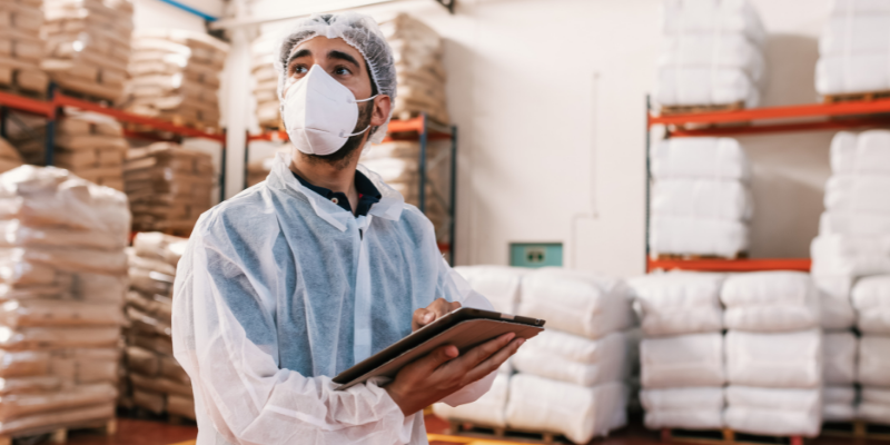 man using tablet in warehouse