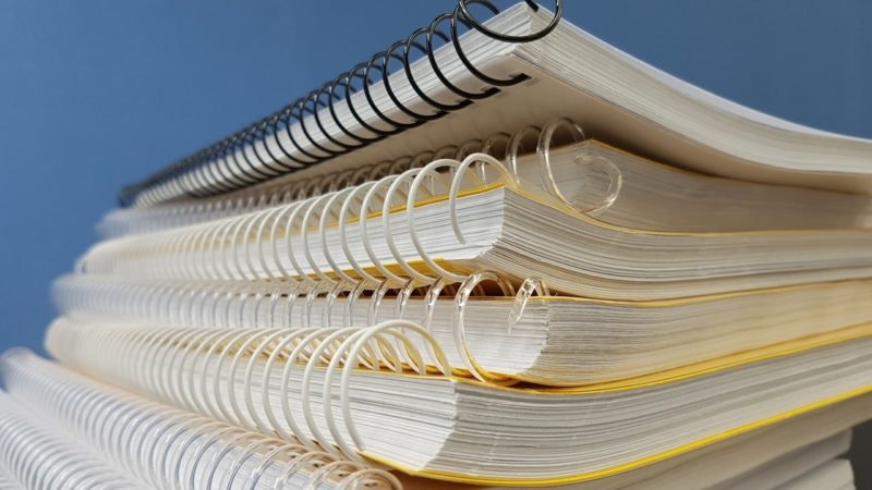 Stack of spiral bound notebooks.