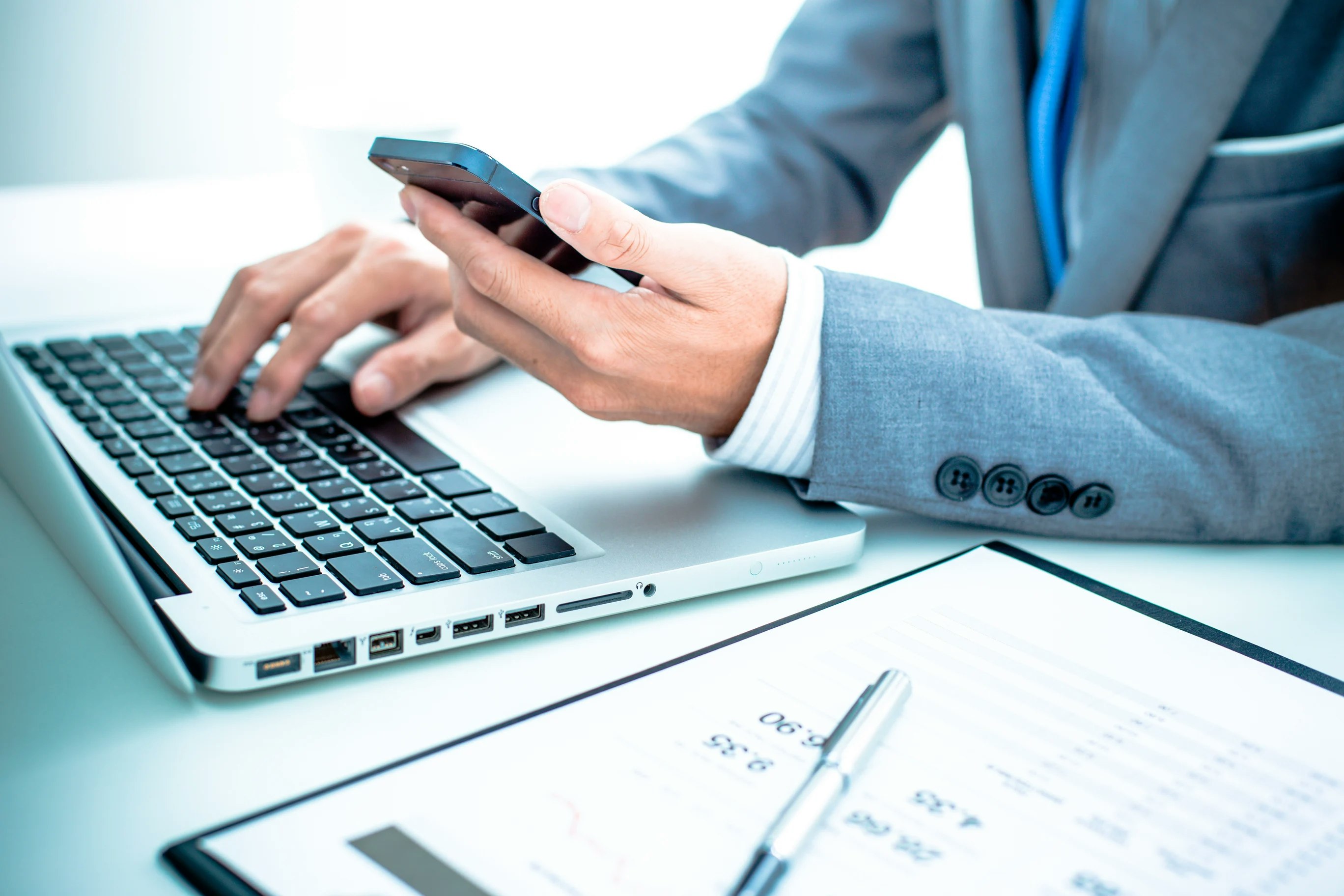 man with laptop and cell phone