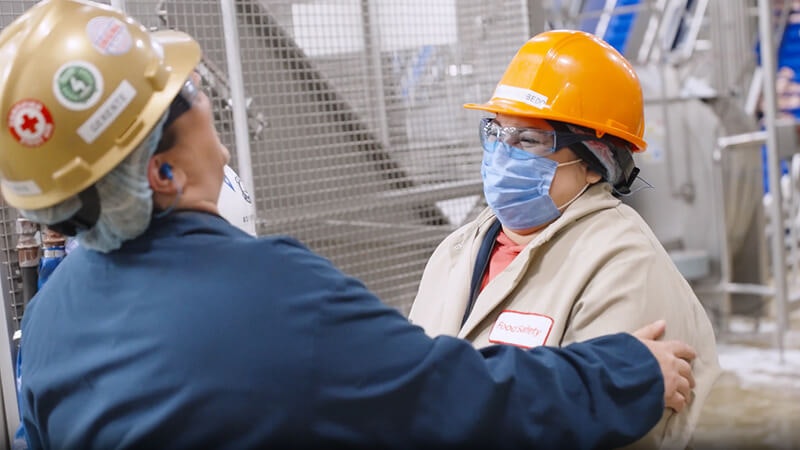 Plant supervisor and operator chatting on the plant floor