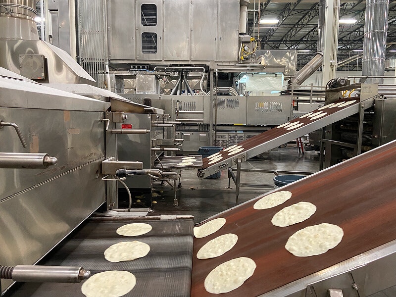 Fresca Mexican Foods tortillas on a conveyor belt