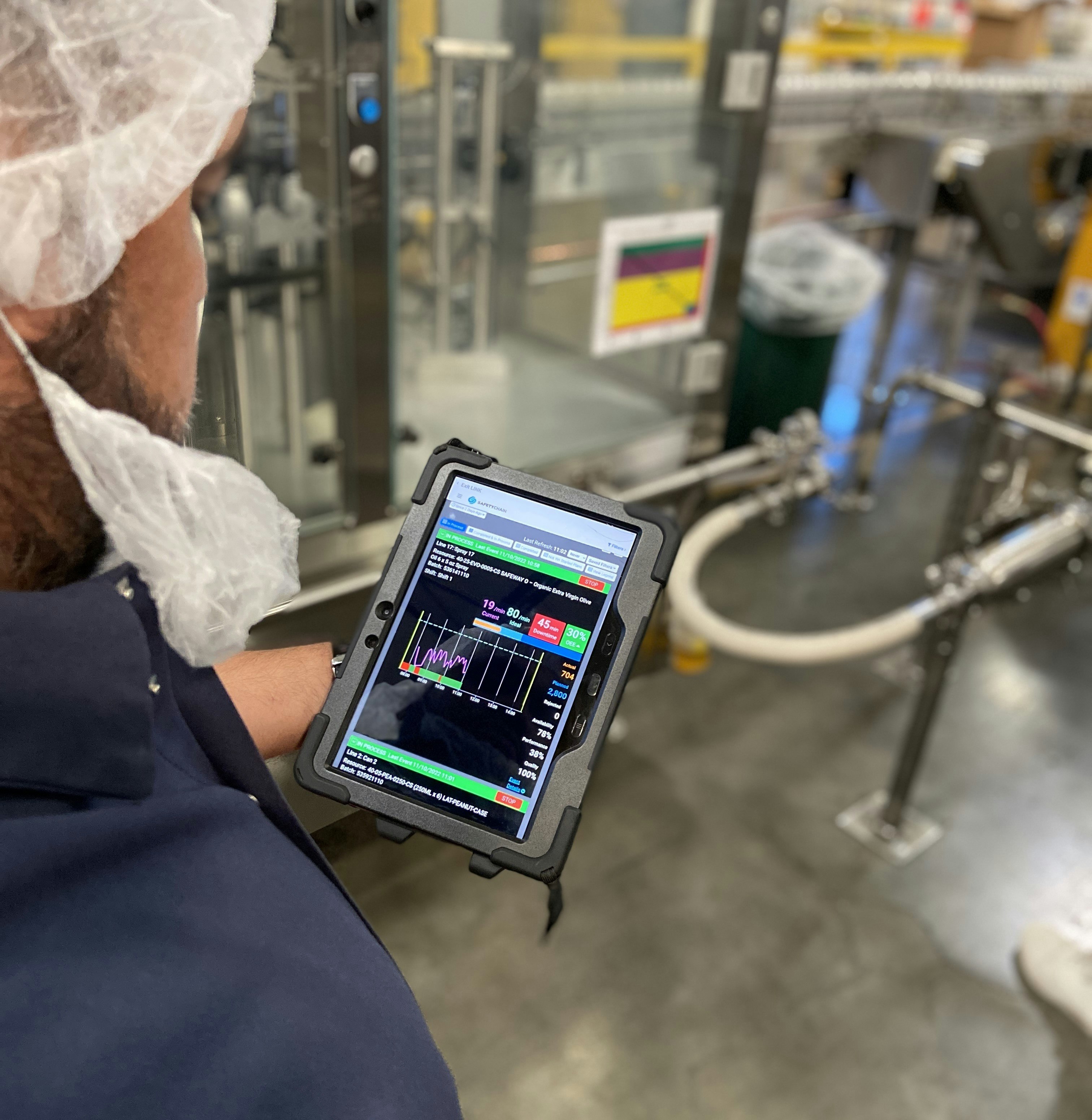 Production manager reviews real time performance on mobile device
