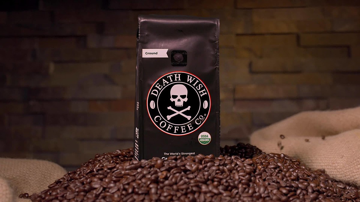 Death Wish Coffee bag of coffee grounds placed on pile of coffee beans